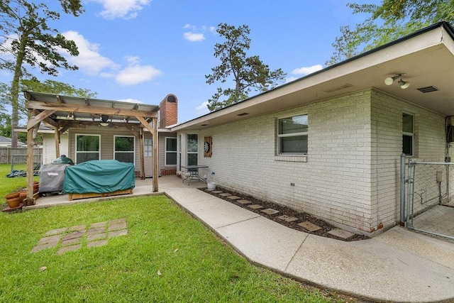708 W Colorado Ave, Hammond, LA 70401 - back of property featuring brick siding, a pergola, a patio area, and a chimney