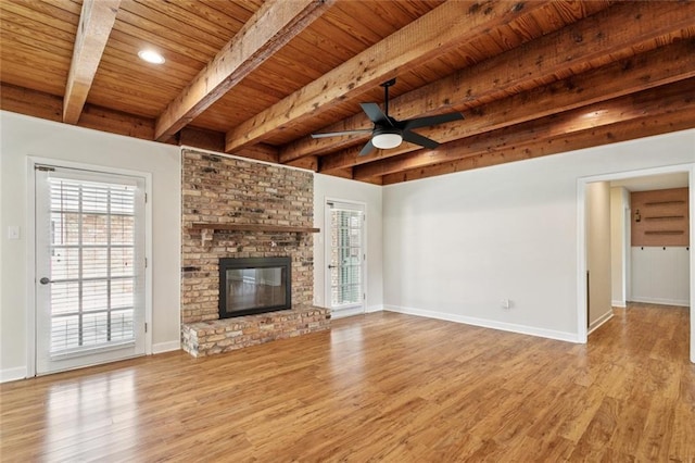 811 Franklin Ct, Slidell, LA 70458 - unfurnished living room with a wooden ceiling with exposed beams, wood finished floors, healthy amount of natural light, a ceiling fan, and a fireplace