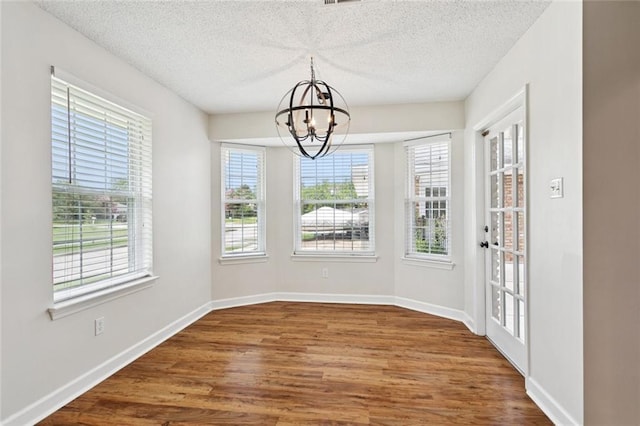 811 Franklin Ct, Slidell, LA 70458 - unfurnished dining area featuring a chandelier, wood finished floors, and a textured ceiling