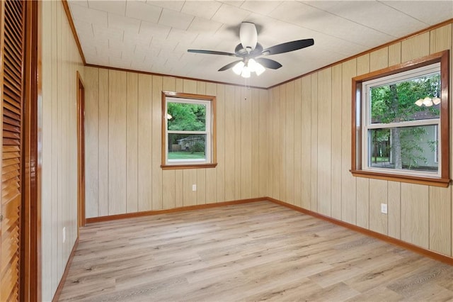 310 Blackburn Rd, Hammond, LA 70401 - spare room featuring healthy amount of natural light, ornamental molding, ceiling fan, light wood-type flooring, and wooden walls