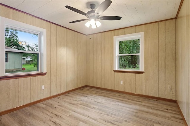 310 Blackburn Rd, Hammond, LA 70401 - unfurnished room featuring healthy amount of natural light, ceiling fan, light wood-style floors, and wood walls