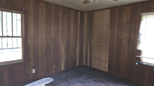 221 College Rd, Eunice, LA 70535 - spare room with wooden walls, plenty of natural light, and ceiling fan