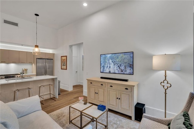 5940 Magazine St Unit 102, New Orleans, LA 70115 - living area with a towering ceiling, light wood-type flooring, and recessed lighting