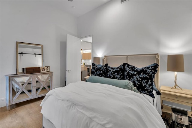 5940 Magazine St Unit 102, New Orleans, LA 70115 - bedroom featuring wood finished floors and a towering ceiling
