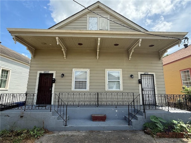 482022 Dauphine St, New Orleans, LA 70117 - shotgun-style home featuring covered porch
