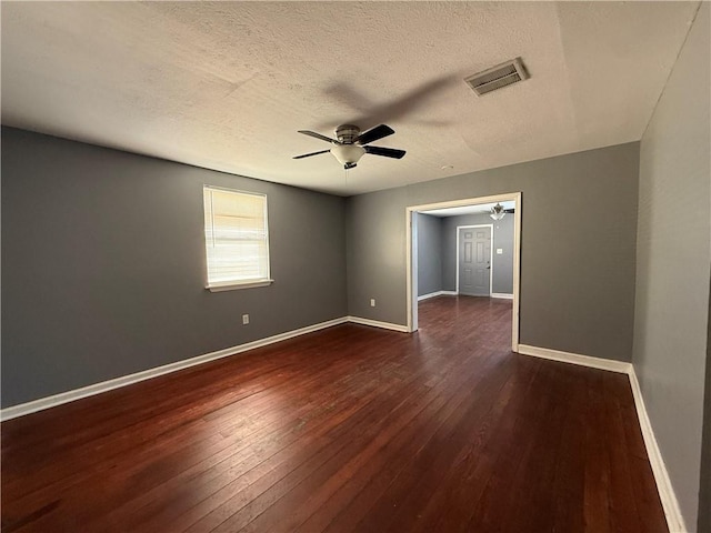482022 Dauphine St, New Orleans, LA 70117 - empty room with a ceiling fan, dark wood-type flooring, and a textured ceiling