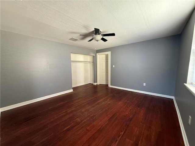 482022 Dauphine St, New Orleans, LA 70117 - unfurnished bedroom with dark wood finished floors and a ceiling fan