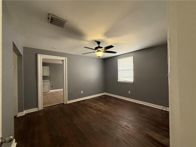 482022 Dauphine St, New Orleans, LA 70117 - unfurnished bedroom featuring dark wood-type flooring and a ceiling fan