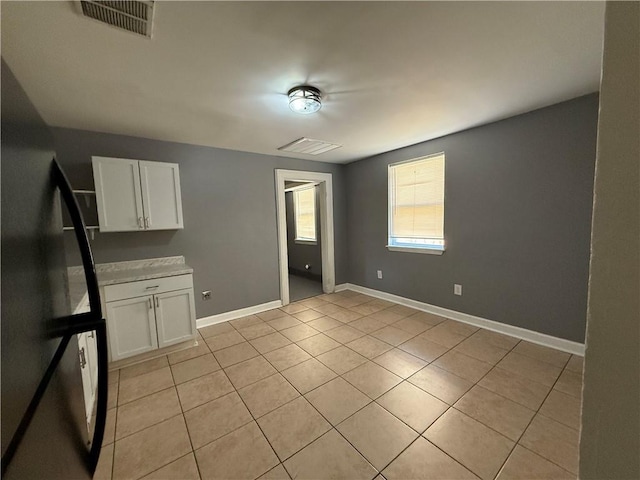 482022 Dauphine St, New Orleans, LA 70117 - unfurnished dining area featuring light tile patterned flooring and baseboards