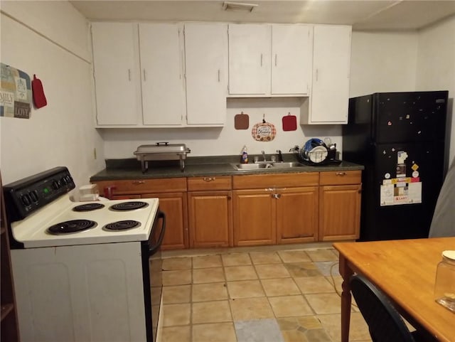 482022 Dauphine St, New Orleans, LA 70117 - kitchen with white range with electric stovetop, freestanding refrigerator, white cabinets, and dark countertops