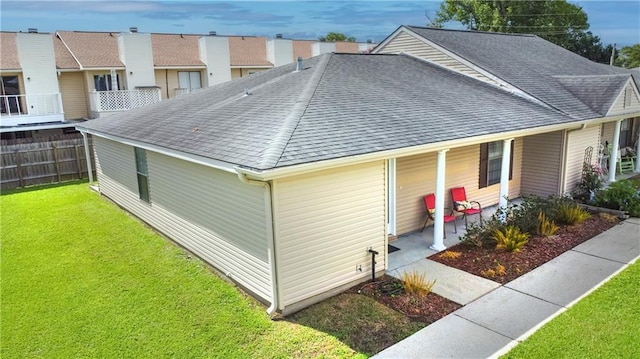 1700 Marseille Dr Unit 16, La Place, LA 70068 - view of side of property featuring a shingled roof and a patio area