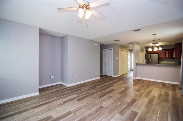 1700 Marseille Dr Unit 16, La Place, LA 70068 - unfurnished living room with light wood-style flooring, a chandelier, and ceiling fan
