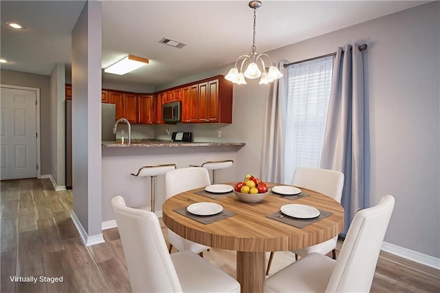 1700 Marseille Dr Unit 16, La Place, LA 70068 - dining room with wood finished floors, a chandelier, and recessed lighting