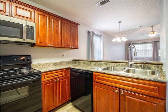 1700 Marseille Dr Unit 16, La Place, LA 70068 - kitchen with black appliances, a textured ceiling, a chandelier, light wood finished floors, and a ceiling fan