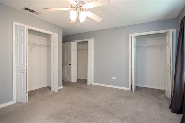 1700 Marseille Dr Unit 16, La Place, LA 70068 - unfurnished bedroom featuring two closets, carpet floors, and a ceiling fan