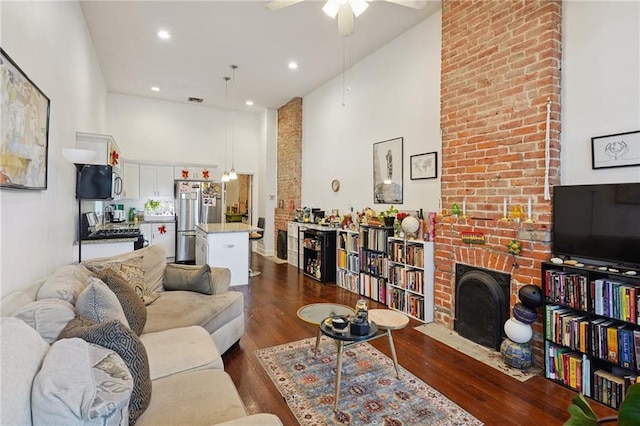 232830 Bienville St, New Orleans, LA 70119 - living area with ceiling fan, dark wood-style floors, a fireplace, a high ceiling, and recessed lighting