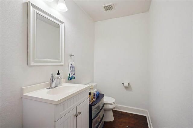 232830 Bienville St, New Orleans, LA 70119 - half bathroom with vanity and wood finished floors