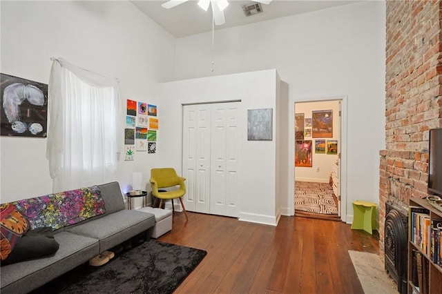 232830 Bienville St, New Orleans, LA 70119 - living area featuring hardwood / wood-style floors, a ceiling fan, and a towering ceiling