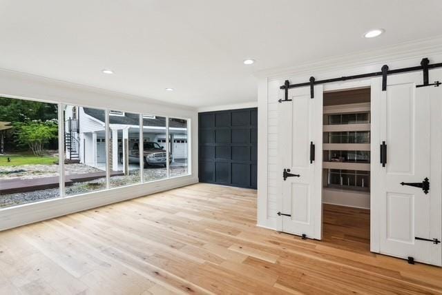 107 Quail St, Slidell, LA 70460 - unfurnished room featuring a barn door, light wood-style floors, and recessed lighting