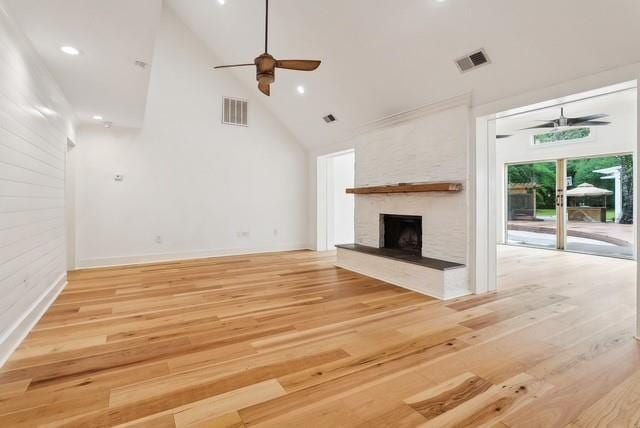 107 Quail St, Slidell, LA 70460 - unfurnished living room with a ceiling fan, high vaulted ceiling, light wood-style flooring, a stone fireplace, and recessed lighting