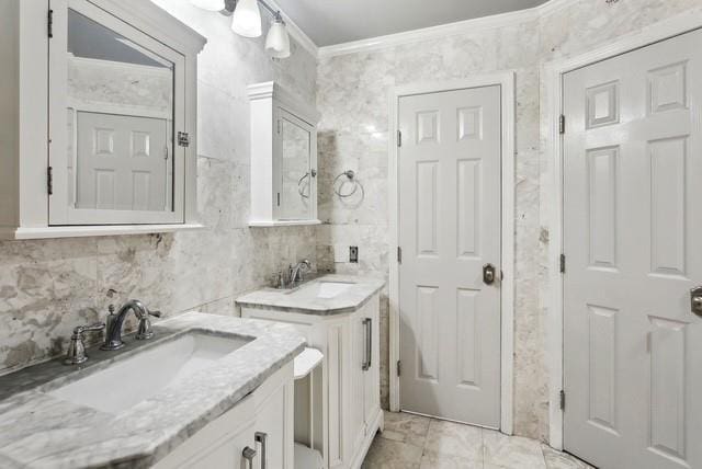 107 Quail St, Slidell, LA 70460 - bathroom featuring two vanities, ornamental molding, backsplash, and marble look tiles