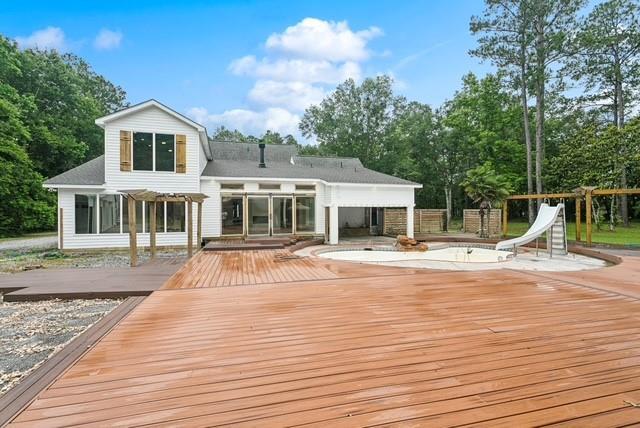 107 Quail St, Slidell, LA 70460 - back of house with a pergola and a wooden deck
