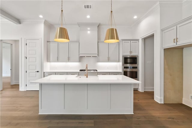 1337 Avenue Lacroix Ave, Lacroix, Covington, LA 70433 - kitchen featuring appliances with stainless steel finishes, light countertops, a center island with sink, crown molding, and wood finished floors