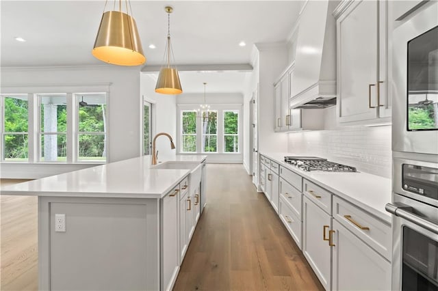 1337 Avenue Lacroix Ave, Lacroix, Covington, LA 70433 - kitchen featuring premium range hood, stainless steel gas cooktop, light countertops, a center island with sink, and recessed lighting