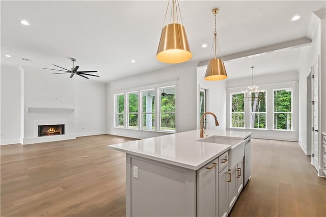 1337 Avenue Lacroix Ave, Lacroix, Covington, LA 70433 - kitchen featuring light countertops, a center island with sink, light wood finished floors, recessed lighting, and a lit fireplace