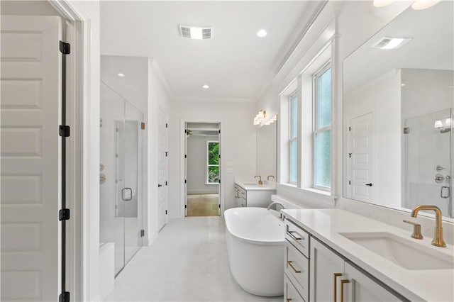 1337 Avenue Lacroix Ave, Lacroix, Covington, LA 70433 - bathroom featuring a stall shower, two vanities, ornamental molding, a freestanding bath, and recessed lighting