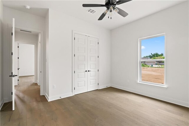 1337 Avenue Lacroix Ave, Lacroix, Covington, LA 70433 - unfurnished bedroom with wood finished floors, a closet, and a ceiling fan