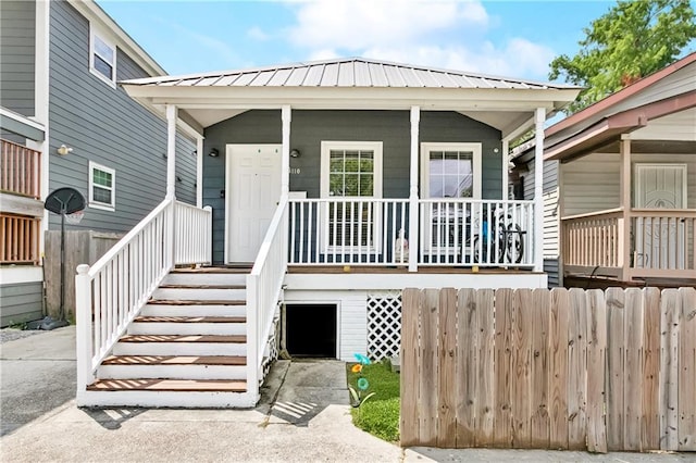 4110 Hollygrove St, New Orleans, LA 70118 - property entrance with a porch and a metal roof