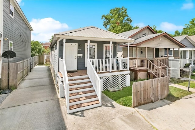 4110 Hollygrove St, New Orleans, LA 70118 - shotgun-style home featuring a porch and stairs