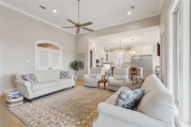 1193 Delta Ln, Covington, LA 70433 - living room with light wood finished floors, ceiling fan, crown molding, and recessed lighting