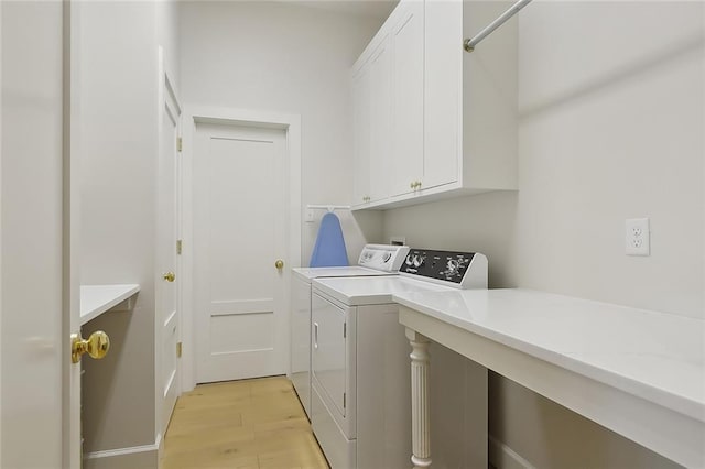 1193 Delta Ln, Covington, LA 70433 - laundry room with cabinet space, washer and dryer, and light wood-type flooring