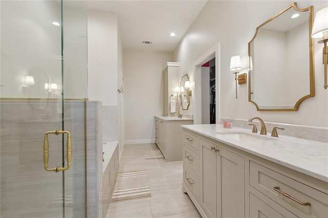 1193 Delta Ln, Covington, LA 70433 - full bath featuring two vanities, a stall shower, tile patterned flooring, a bath, and recessed lighting