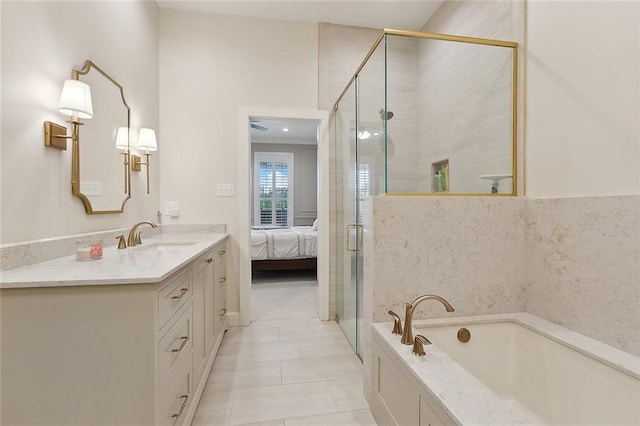 1193 Delta Ln, Covington, LA 70433 - ensuite bathroom featuring vanity, a garden tub, a shower stall, and tile patterned flooring