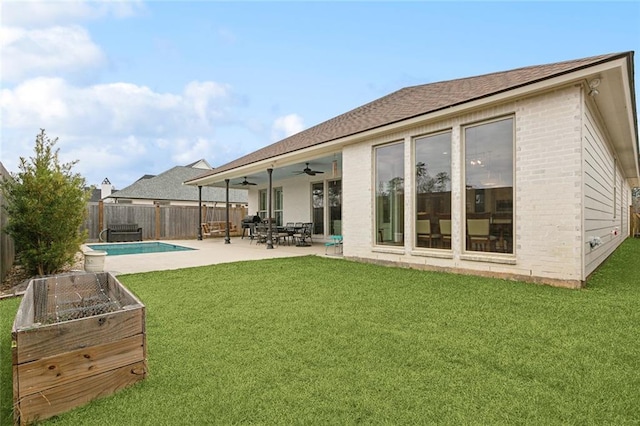 1193 Delta Ln, Covington, LA 70433 - rear view of house featuring a ceiling fan, a fenced backyard, brick siding, and a patio area