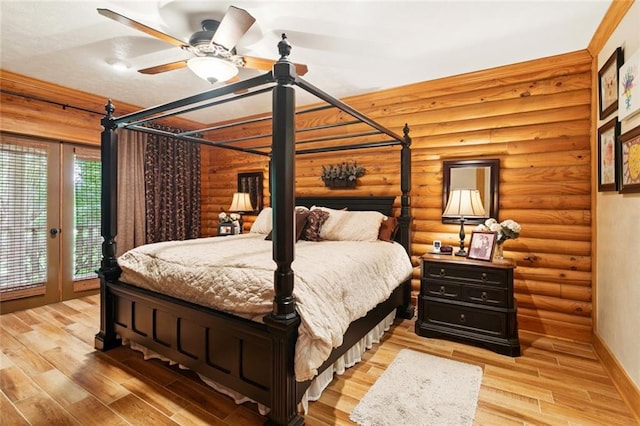 75581 N Hayes Rd, Kentwood, LA 70444 - bedroom featuring access to exterior, light wood-type flooring, and log walls