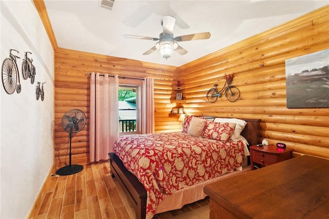 75581 N Hayes Rd, Kentwood, LA 70444 - bedroom with wood finished floors, access to exterior, ceiling fan, and rustic walls