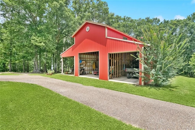 75581 N Hayes Rd, Kentwood, LA 70444 - view of community with a yard, a pole building, an outbuilding, and a garage