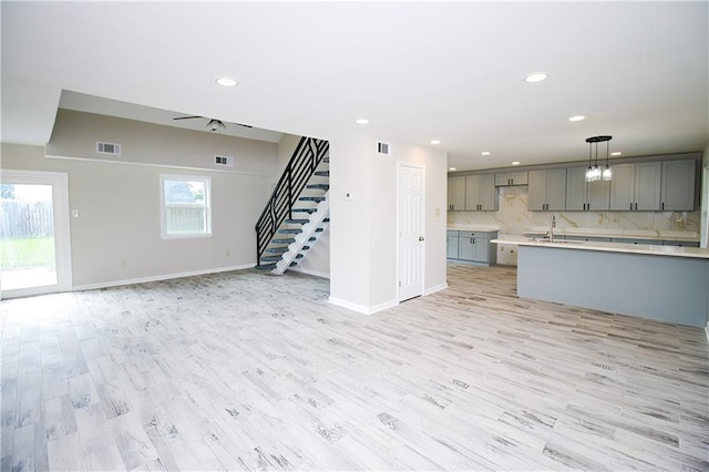 1304 Madewood Rd, La Place, LA 70068 - unfurnished living room featuring recessed lighting, stairway, and light wood-type flooring