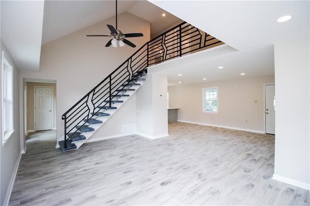 1304 Madewood Rd, La Place, LA 70068 - unfurnished living room with ceiling fan, wood finished floors, stairs, recessed lighting, and high vaulted ceiling