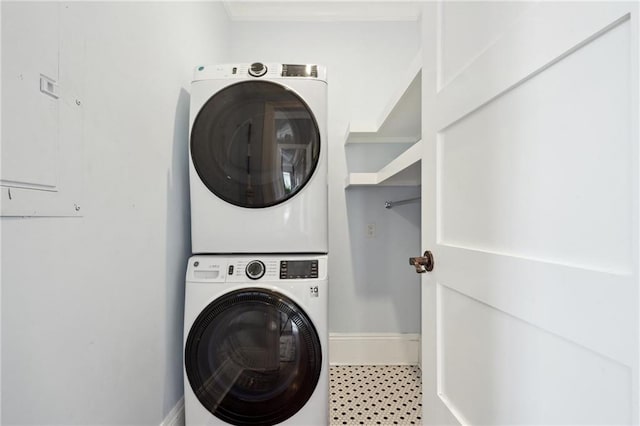 1529 St Philip St, New Orleans, LA 70116 - washroom with stacked washing machine and dryer and baseboards