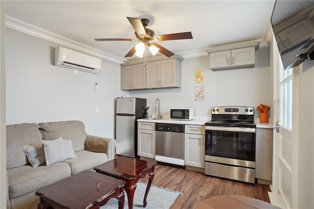 1529 St Philip St, New Orleans, LA 70116 - kitchen with stainless steel appliances, an AC wall unit, crown molding, light countertops, and dark wood-style flooring