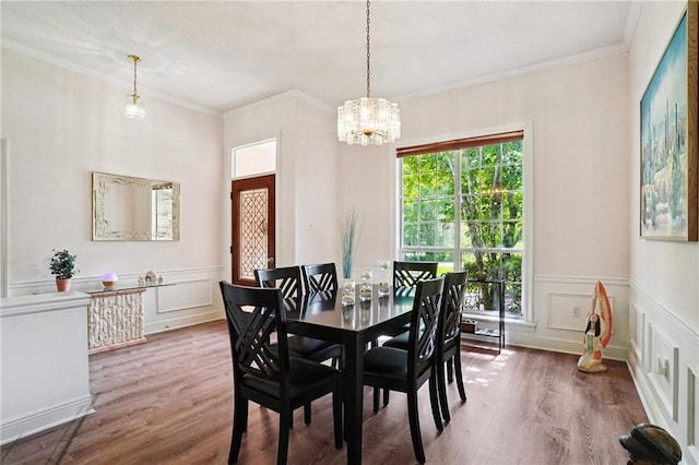 67061 Dolan St, Mandeville, LA 70471 - dining room with a chandelier, wood finished floors, a decorative wall, crown molding, and a wainscoted wall