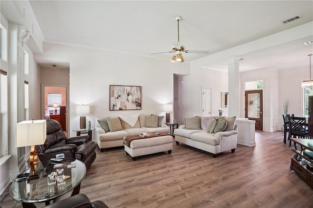 67061 Dolan St, Mandeville, LA 70471 - living area featuring wood finished floors, ceiling fan, ornamental molding, and decorative columns