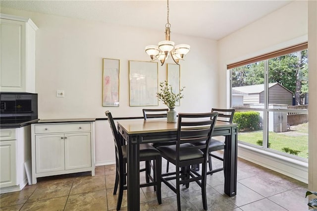 67061 Dolan St, Mandeville, LA 70471 - tiled dining area featuring a chandelier and plenty of natural light