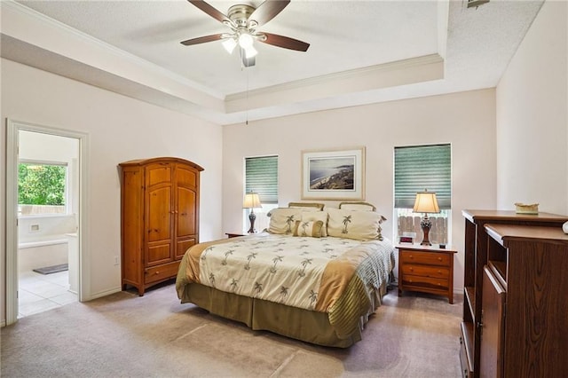 67061 Dolan St, Mandeville, LA 70471 - bedroom with light colored carpet, ornamental molding, a raised ceiling, connected bathroom, and a ceiling fan
