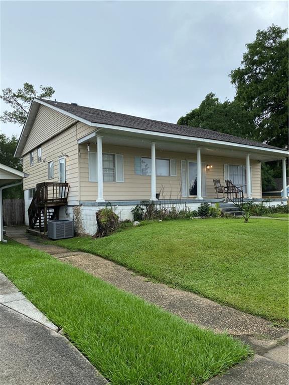 208 Amapola Cir, Terrytown, LA 70056 - view of front of property featuring a front lawn, a porch, and a shingled roof